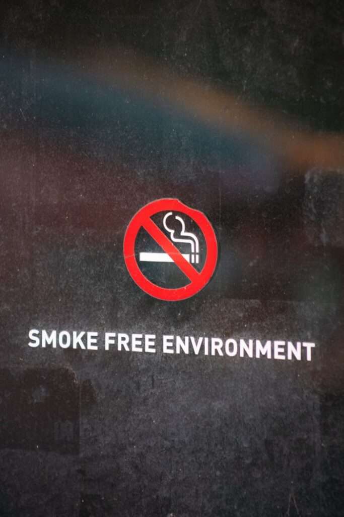 Close-up of no smoking sign indicating a smoke-free environment on a reflective surface.